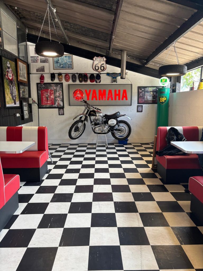 Image of cafe with Yamaha motorbike on the wall
